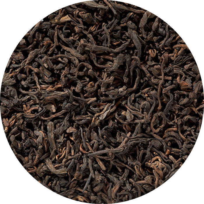 Hojas secas de té Pu Erh rojo oscuro con tonos marrones y textura rizada.