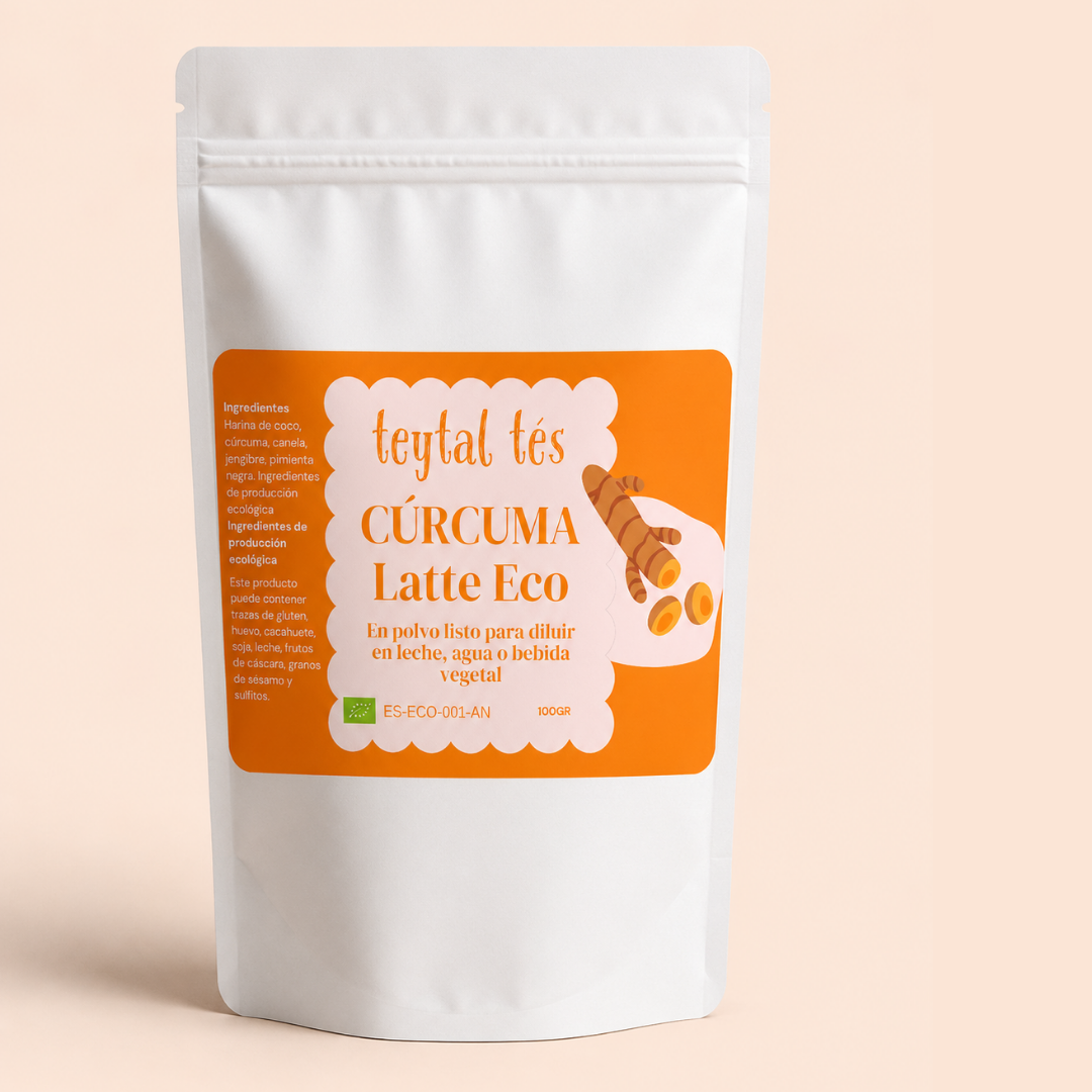 Bolsa blanca con etiqueta naranja de cúrcuma latte ecológico en polvo, 100 g, diseño con ilustración de cúrcuma y texto.
